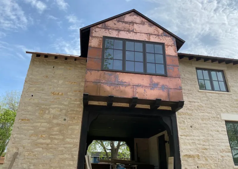 Copper metal panel facade on a stone building for Skylight Installation in Pacific Grove